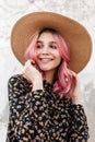 Happy portrait beautiful young woman with lovely smile with glamorous pink hair in vintage stylish straw hat in fashionable black Royalty Free Stock Photo