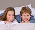 Happy, portrait and brother with sister, bed and smile with holiday and children with bedroom. Face, siblings or boy Royalty Free Stock Photo