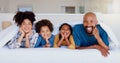 Happy, portrait and children with parents in bed of modern home for bonding together with love. Smile, fun and young Royalty Free Stock Photo