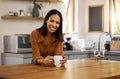 Happy portrait, coffee and woman at house in a kitchen with a hot drink feeling relax and calm in the morning. Happiness