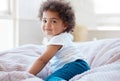 Happy portrait, girl and kid in bedroom for fun, childhood development and baby growth with curly hair. Cute, adorable Royalty Free Stock Photo