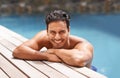 Happy, portrait and man relax in pool on vacation in summer with happiness at hotel, resort or villa in Miami. Calm Royalty Free Stock Photo