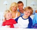 Happy, portrait and parents with boys on bed for bonding, relaxing and spending time together. Smile, love and young Royalty Free Stock Photo