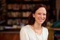 Happy, portrait of woman librarian and in a library with a smile for education. Reading or learning, studying academic Royalty Free Stock Photo