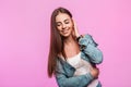 Happy portrait young woman fashion model with sweet smile in stylish blue denim clothes near pink vintage wall. Cheerful Royalty Free Stock Photo