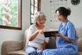 A happy and positive Asian old woman visiting doctor in the hospital office Royalty Free Stock Photo