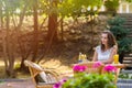 Happy, positive, beautiful, elegance girl sitting at cafe table outdoors.