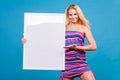 Happy positive blonde woman holding blank white board Royalty Free Stock Photo