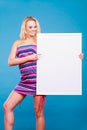 Happy positive blonde woman holding blank white board Royalty Free Stock Photo