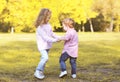 Happy positive children having fun in autumn day