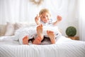 Happy positive children, tickling on the feet, having fun together, boy and girl at home having wonderful day of joy Royalty Free Stock Photo