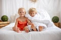 Happy positive children, tickling on the feet, having fun together, boy and girl at home having wonderful day of joy Royalty Free Stock Photo