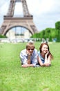 Happy positive couple laying on the grass