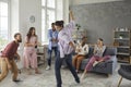 Group of happy young multiethnic friends dancing and having fun at a party at home Royalty Free Stock Photo