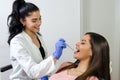 Happy positive female dentist checking braces