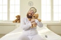 Happy funny grown-up man in pajamas cuddling his favorite teddy bear like a baby Royalty Free Stock Photo