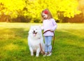 Happy positive little girl and dog having fun