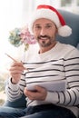 Happy positive man holding a pencil