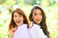 Happy positive moments of two girls in park. Closeup portrait funny joyful young women having fun, smiling, lovely Royalty Free Stock Photo