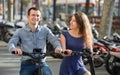 Happy young man and woman with electrkc bikes