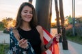 Positive smiling young woman with sparklers and USA flag portrait at the sunset in park Royalty Free Stock Photo