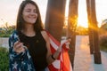 Positive smiling young woman with sparklers and USA flag portrait at the sunset in park Royalty Free Stock Photo