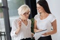 Happy positive woman showing her colleague a document Royalty Free Stock Photo