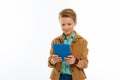 Happy positive young boy holding his tablet