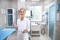 Cheerful woman enjoying work in clinic stock photo