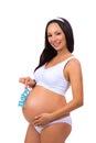 Happy pregnancy. Smiling pregnant woman holding near tummy blue label Baby for newborn boy Royalty Free Stock Photo