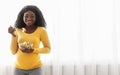 Happy pregnant african american woman eating fresh salad at home Royalty Free Stock Photo