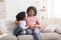 Happy Pregnant Afro Woman Relaxing On Couch With Her Little Daughter Royalty Free Stock Photo