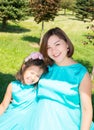 Happy pregnant asian mom and child girl hugging. The concept of childhood and family. Beautiful Mother and her baby outdoor Royalty Free Stock Photo