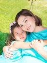 Happy pregnant asian mom and child girl hugging. The concept of childhood and family. Beautiful Mother and her baby outdoor Royalty Free Stock Photo