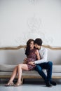 Happy pregnant couple at home, young loving family pregnancy, Portrait of man and woman expecting baby sitting at home Royalty Free Stock Photo