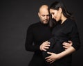 Happy Pregnant Couple looking at Belly. Mother and Father Love expecting Baby during Pregnancy. Family waiting Child Birth