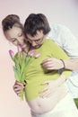 Happy pregnant couple with tulips Royalty Free Stock Photo