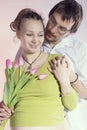 Happy pregnant couple with tulips Royalty Free Stock Photo