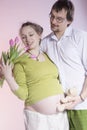 Happy pregnant couple with tulips Royalty Free Stock Photo