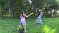 Happy pregnant mother with daughter play badminton game