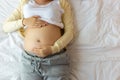 Happy pregnant mother touching beautiful belly laying down in cozy bed at home. prenatal, pregnancy, motherhood, expect concept Royalty Free Stock Photo