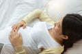 Happy pregnant mother touching beautiful belly laying down in cozy bed at home. prenatal, pregnancy, motherhood, expectation Royalty Free Stock Photo
