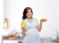 Happy pregnant woman with apple and croissant Royalty Free Stock Photo