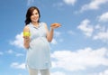 Happy pregnant woman with apple and croissant Royalty Free Stock Photo