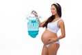 Happy pregnant woman with baby clothing for newborn boy