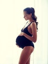 Happy pregnant woman with big bare tummy at home Royalty Free Stock Photo