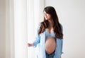 Happy pregnant woman with big tummy at home Royalty Free Stock Photo