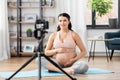 Happy pregnant woman blogger recording yoga video Royalty Free Stock Photo