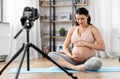 Happy pregnant woman blogger recording yoga video Royalty Free Stock Photo