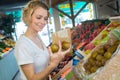 happy pregnant woman buying pears Royalty Free Stock Photo